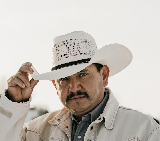 Man tipping white cowboy hat
